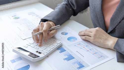 Accounting businesswomen are calculating income-expenditure and analyzing real estate investment data, Dedicated to the progress and growth of the company, Financial and tax systems concept.