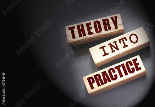 Theory into practice words written on wooden blocks. Education or business startup concept