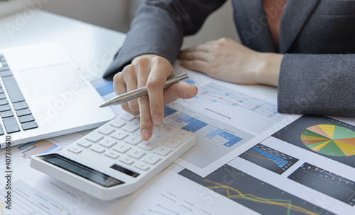 Accounting businesswomen are calculating income-expenditure and analyzing real estate investment data, Dedicated to the progress and growth of the company, Financial and tax systems concept.