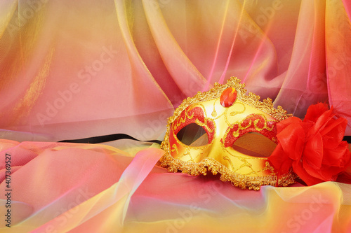 Fototapeta Naklejka Na Ścianę i Meble -  Photo of elegant and delicate pink Venetian mask over colorful chiffon background