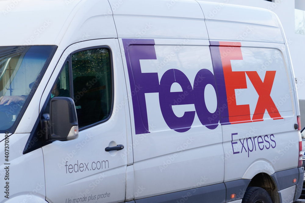 Fedex express logo and sign on panel delivery van truck in city street ...
