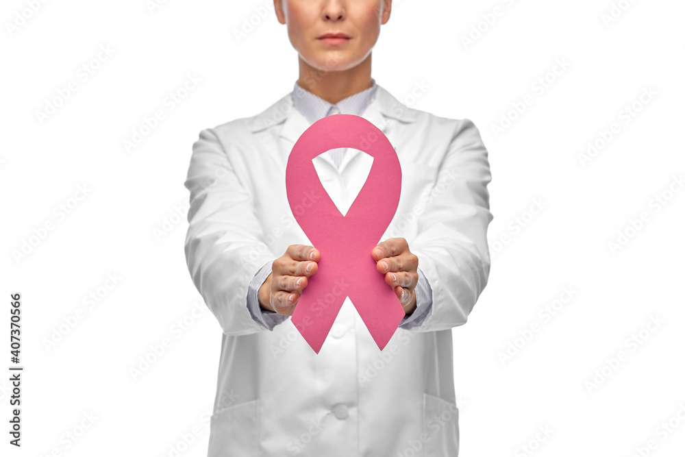 medicine, healthcare and oncology concept - close up of female doctor in white coat with pink breast cancer awareness ribbon medicine, healthcare and oncology concept - close up of female doctor in white coat with pink breast cancer awareness ribbon