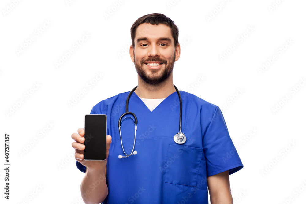 medicine, healthcare and technology concept - happy smiling doctor or male nurse in blue uniform with smartphone and stethoscope over white background medicine, healthcare and technology concept - happy smiling doctor or male nurse in blue uniform with smartphone and stethoscope over white background