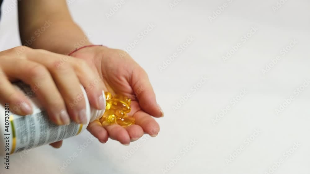 omega 3 vitamins in hand. selective focus omega 3 vitamins in hand. selective focus