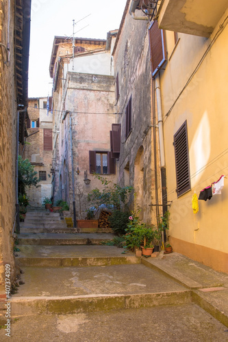 Fototapeta Naklejka Na Ścianę i Meble -  A quiet residential street in the historic medieval village of Montalcino in Siena  province, Tuscany, Italy
