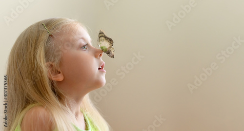 Canvas Print The girl looks in surprise at a butterfly with wings from a 1000 dollar bill tha