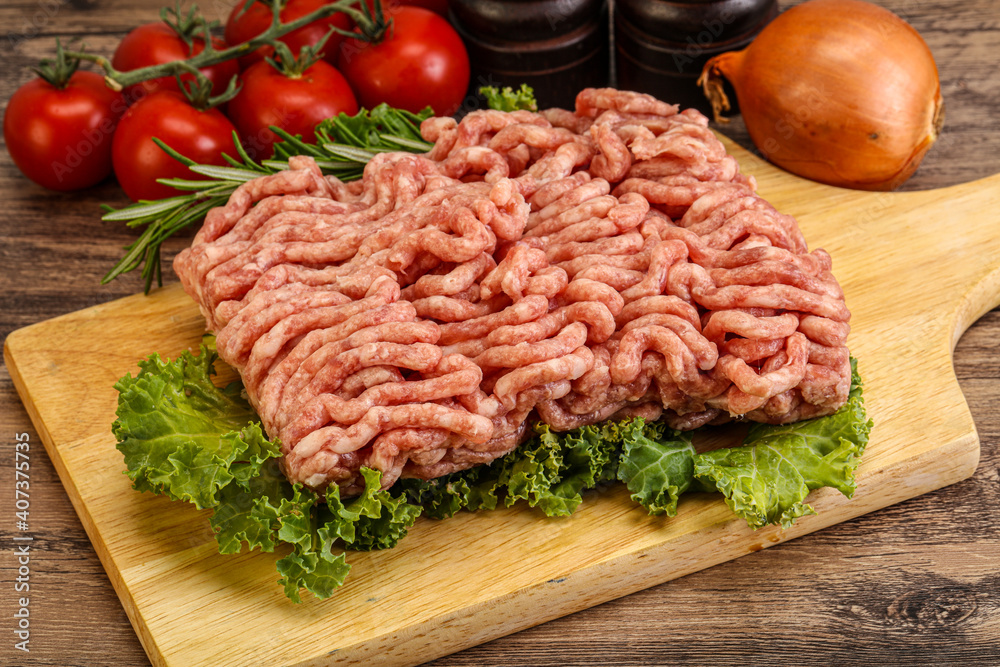 Raw pork minced meat over board Raw pork minced meat over board