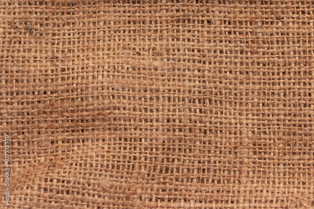 The texture of an uneven crumpled, roughly woven burlap. The texture of an uneven crumpled, roughly woven burlap.