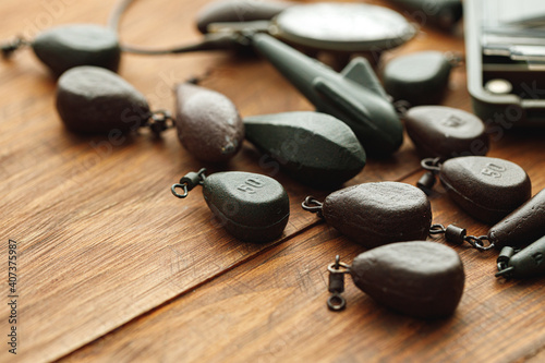 Canvas Print Heap of lead weights for fishing on wooden background