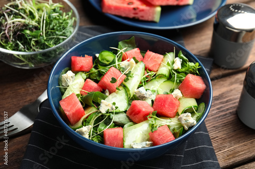 Delicious salad with watermelon served on wooden table