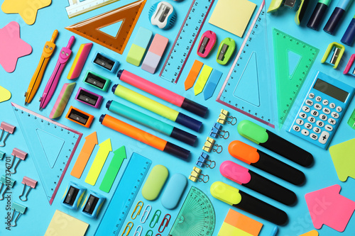 Different stationery on light blue background, flat lay. Back to school
