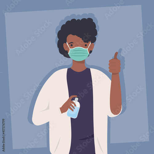 covid prevention, man afro wearing medical mask with bottle antibacterial in hands