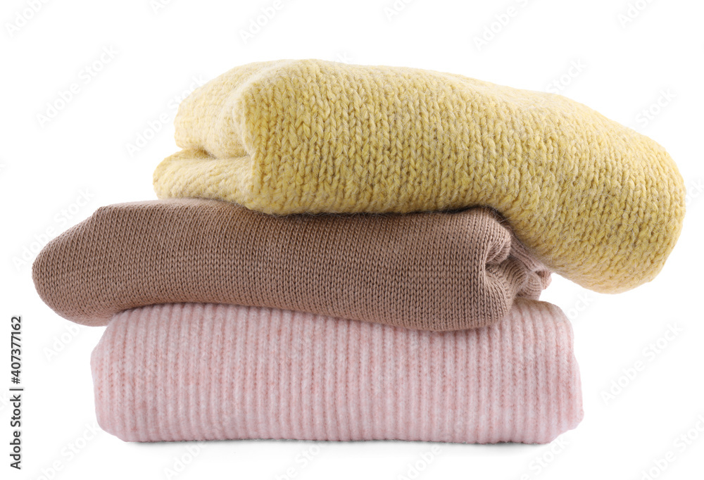 Stack of warm sweaters isolated on white