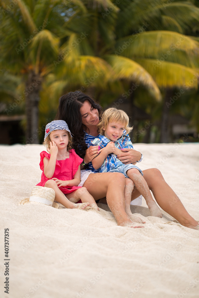 Beautiful mother, son and daughter sitting on the ocean. Beautiful mother, son and daughter sitting on the ocean.