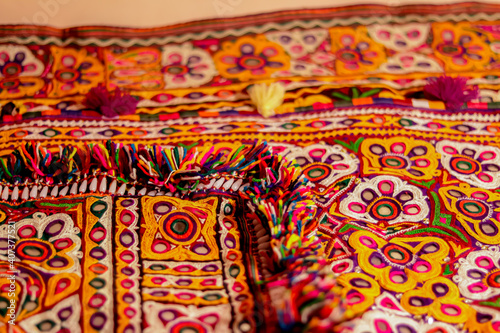 handwork embroidery,Handmade embroidery art. Traditional Indian handmade embroidery art,selective focus,mirror work colorful handmade ahir bharat,Kutch-gujarat
