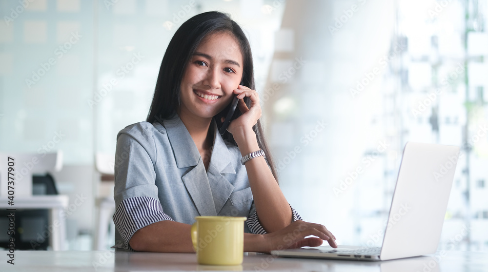 A businesswoman working on new project with laptop computer in modern office. A businesswoman working on new project with laptop computer in modern office.
