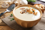 Delicious cream soup with mushrooms on wooden table, closeup