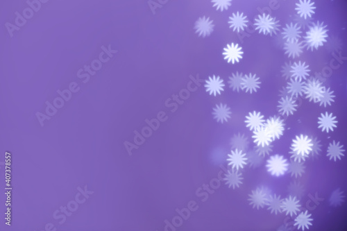 Fototapeta Naklejka Na Ścianę i Meble -  Beautiful snowflake shaped lights on purple background, space for text