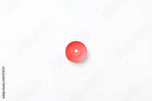 Red small candle isolated on white  top view