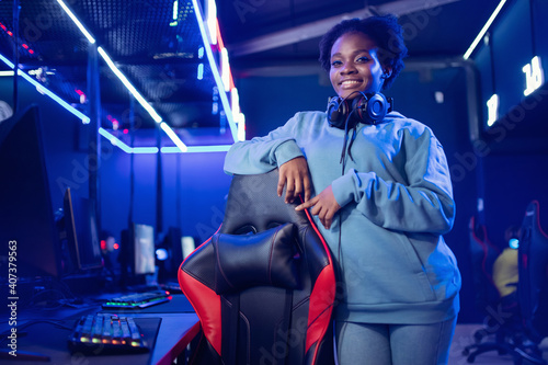 Portrait Streamer African young woman professional gamer playing online games computer, neon color