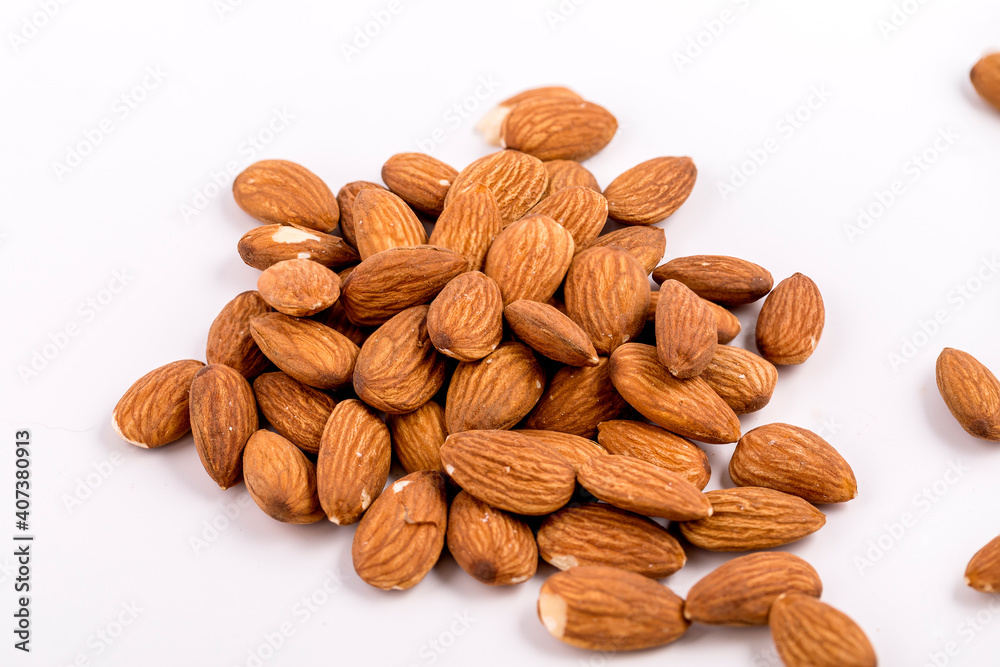 Almonds close up on a white background. Almonds close up on a white background.