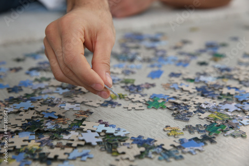 Man playing with puzzles on floor, closeup