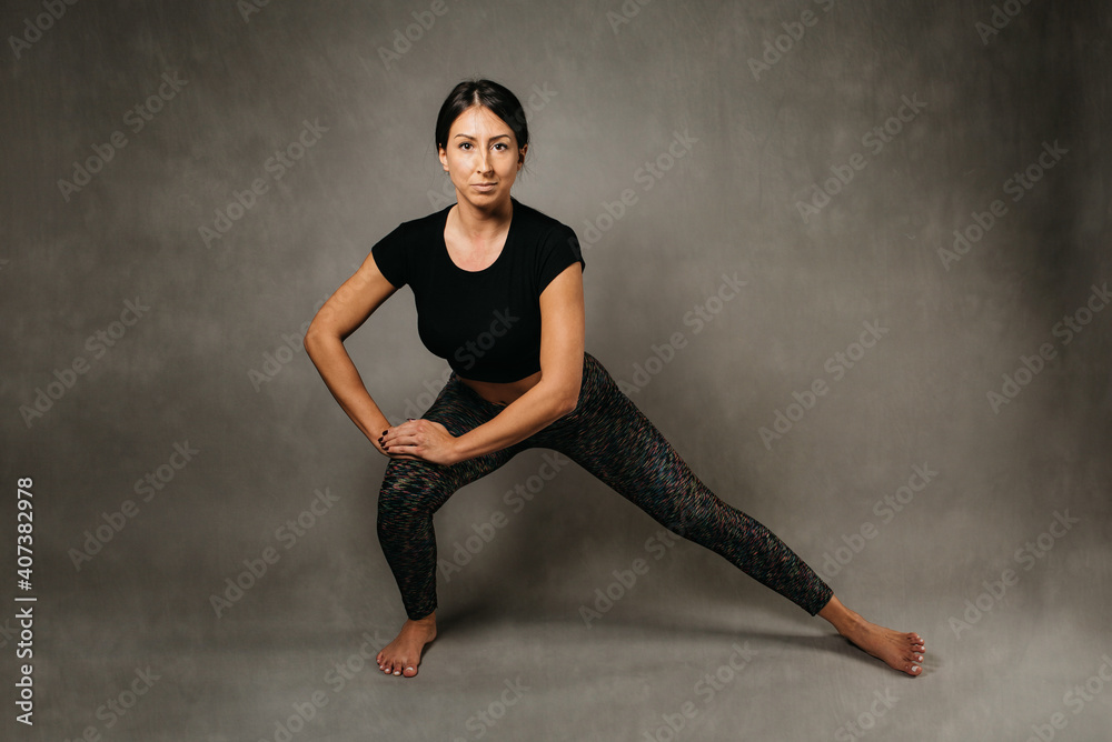 Young attractive girl doing yoga. Relaxation and meditation concept. Studio photo shoot.