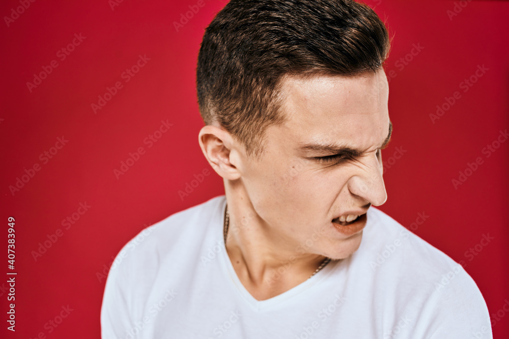 Fototapeta premium Man in white t-shirt emotions displeased facial expression isolated background