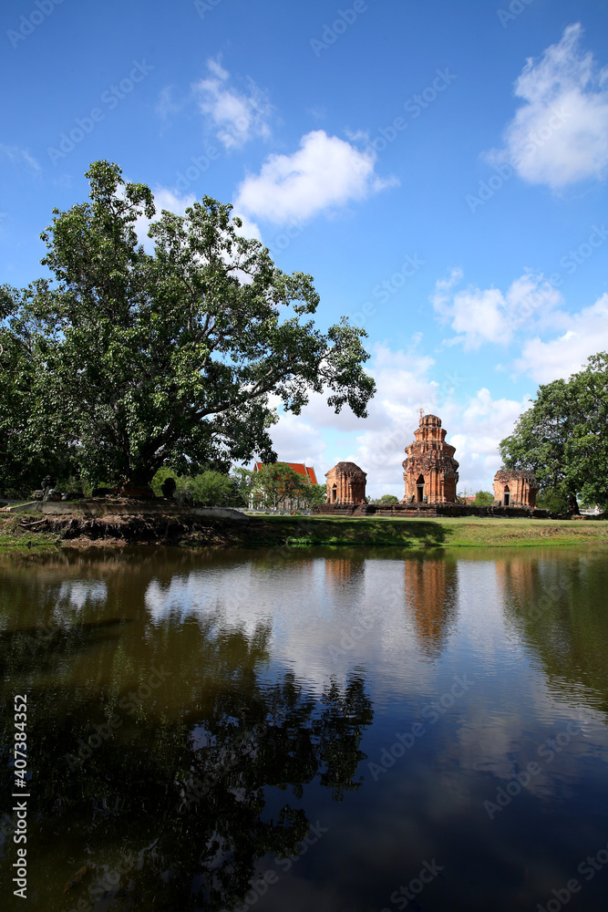 Prasat Sikhoraphum or Castle Rock temple in Surin of Thailand, reflection in pond water with beautiful blue sky and clouds background. 