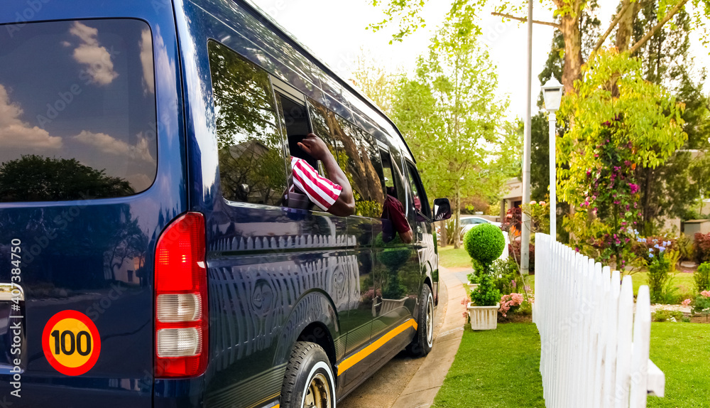 Fototapeta premium Minibus taxi van parked outside a house in a wealthy neighbourhood