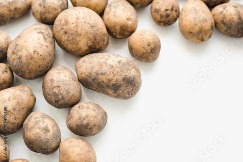 potatoes on white background, dirty potatoes, a bunch of potatoes