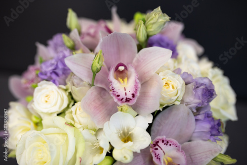 Fresh flowers are collected in a bouquet. A hatbox with flowers in lilac color. © Belogen