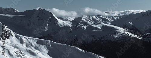 Snow covered mountain peaks in Whistler backcountry, in the Coast Mountains, Garibaldi Provincial Park, British Columbia, Canada
