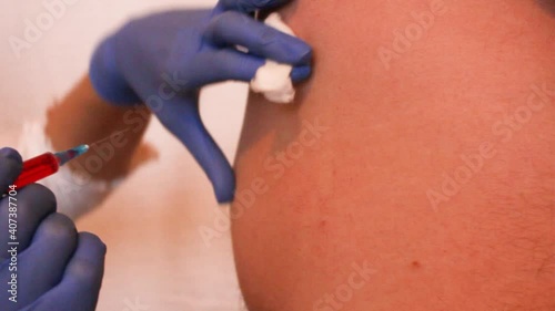 Injection with a syringe in the buttock, ass, in the back, in the muscle, vaccine, injecting vitamins into the blood