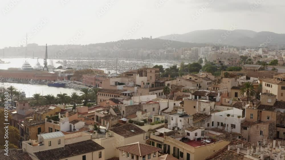 Old town in Palma on the island of Mallorca Spain dron 4K video. Aerial view of historic streets with houses, Mediterranean seafront church with beautiful urban landscape.