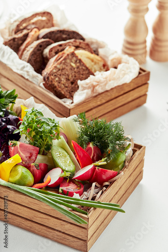 chopped fresh vegetables in a wooden box on a white background. Banquet festive dishes. Gourmet restaurant menu.