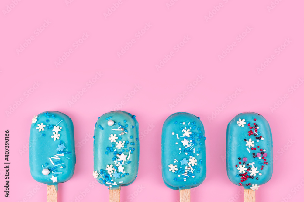 Blue mint ice cream popsicles on pastel pink background. Tasty and refreshing icecream on sticks. Minimal summer concept. Flat lay, free copyspace for text