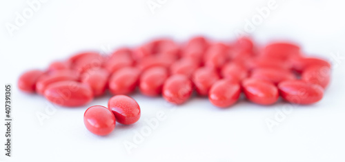 Red vitamins on white background