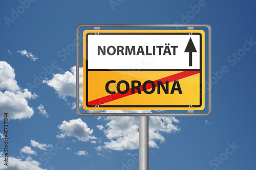 Corona Virus Pandemie vorbei, endlich wieder Normalität - Ortsausgangsschild vor blauem Himmel photo