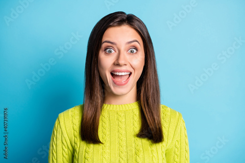 Portrait of young beautiful amazed excited happy smiling girl woman female with open mouth look copyspace isolated on blue color background © deagreez