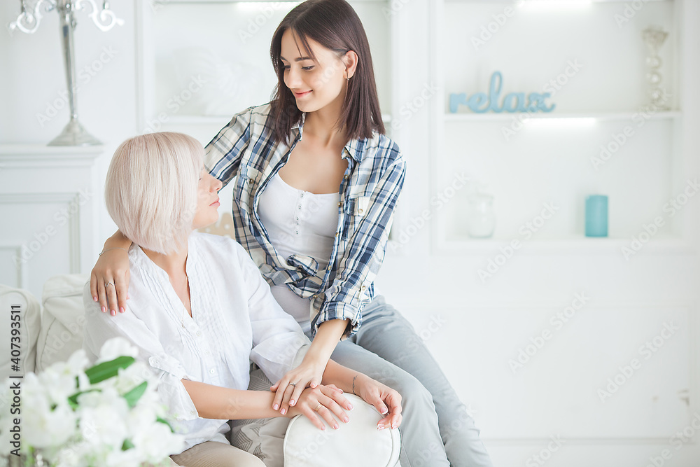 Adult daughter and mother indoors. Women embracing Adult daughter and mother indoors. Women embracing
