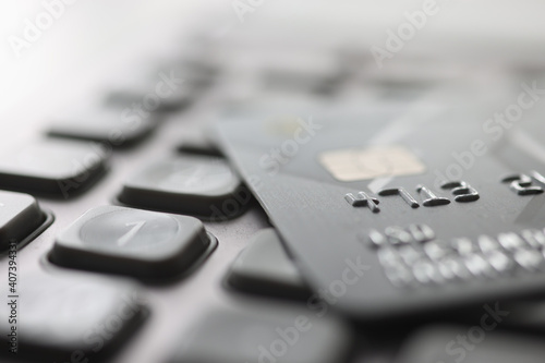 Bank plastic card lying on calculator closeup