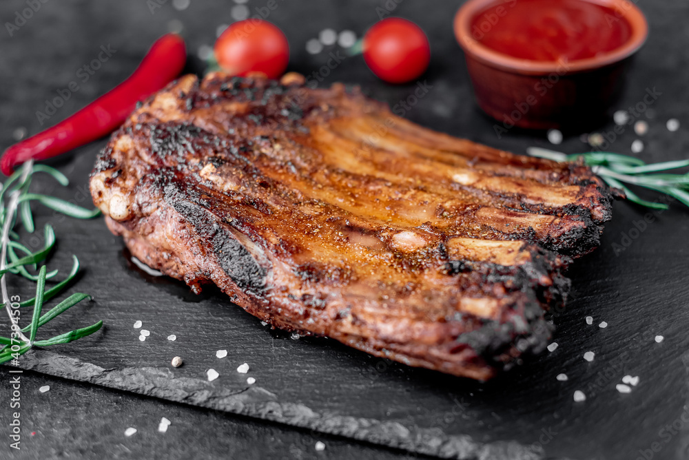 grilled pork ribs on a stone background	
