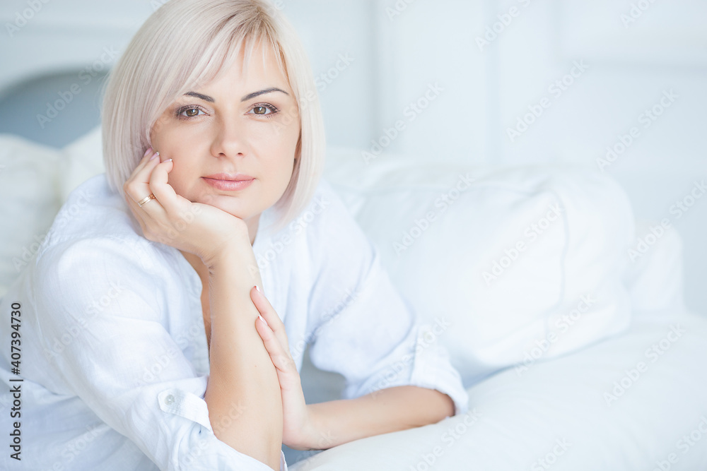 Closeup portrait of midadult blond woman indoors Closeup portrait of midadult blond woman indoors