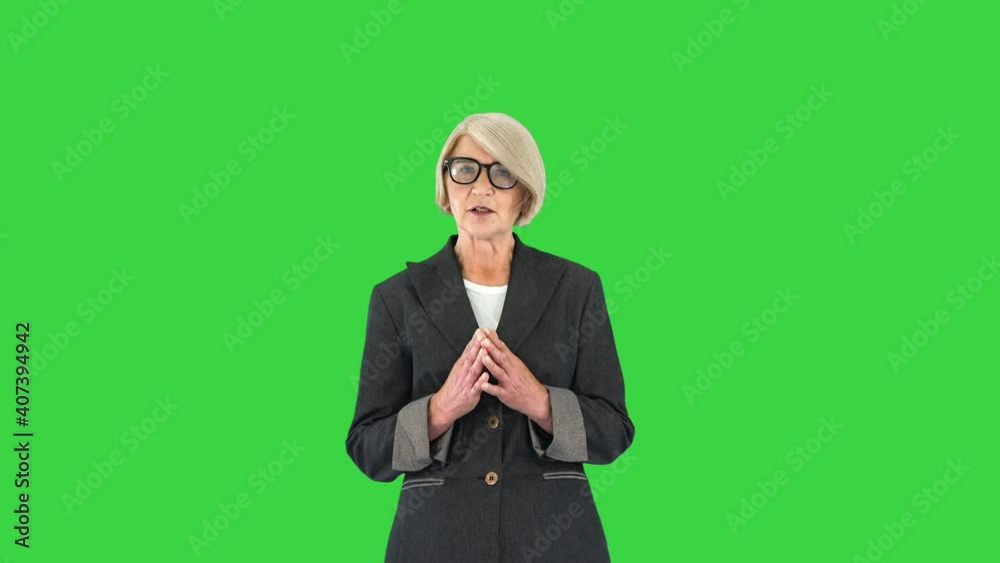 Strict Attractive Senior Woman Talking To Camera on a Green Screen, Chroma Key. Strict Attractive Senior Woman Talking To Camera on a Green Screen, Chroma Key.
