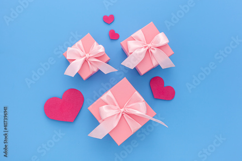 Valentines day composition: three pink gift boxes with ribbon