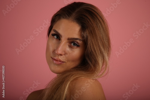 Beautiful woman on pink background in studio