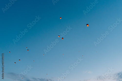 releasing flying lanterns at dusk