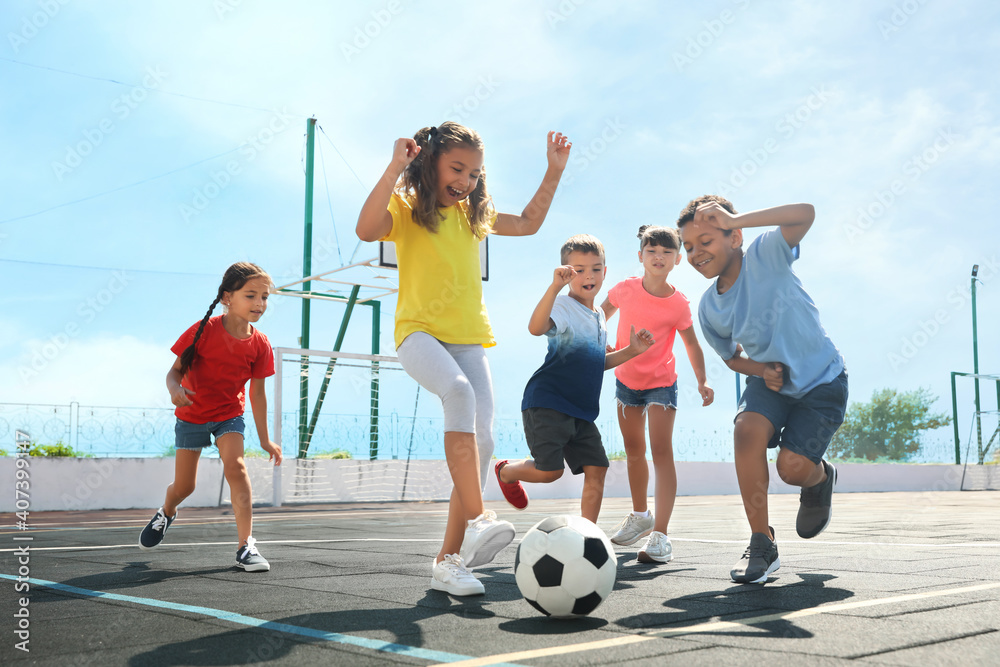 © New Africa - Cute children playing soccer outdoors on sunny day. Summer camp