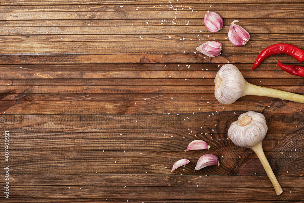 Savory, fresh, garlic and red, hot, chili, pepper, on a wood kitchen table